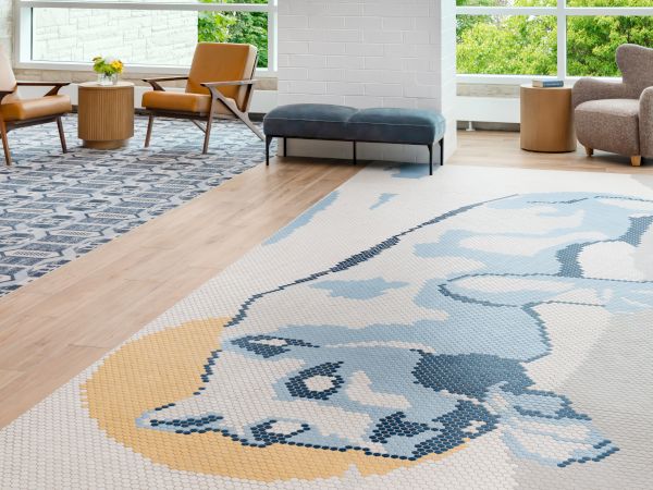 Modern lounge with mid-century chairs, a large panda-pattern rug, and bright, airy windows.