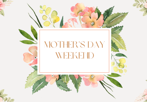 A watercolor floral card with soft pink, peach, and green blooms framing a centered white-bordered message: &ldquo;MOTHER'S DAY WEEKEND.&rdquo;